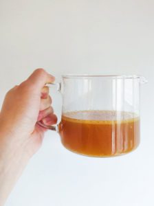 Chicken broth in a cup